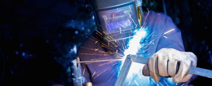 Welder welding structure material with lighting sparks