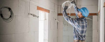 An electrician working in a residential apartment after electrician training