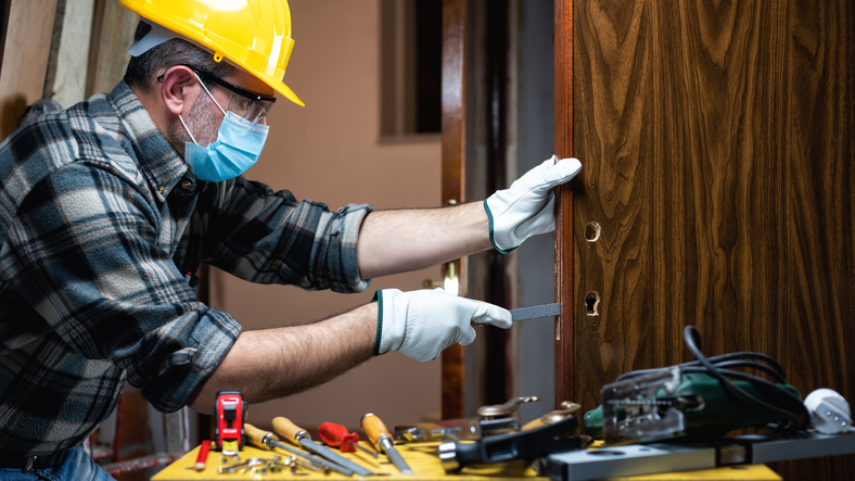 Renovation technician taking floor measurements after home renovation training