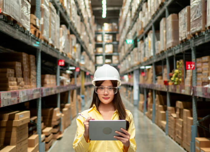 Female logistics manager holding a notepad in a warehouse after logistics training