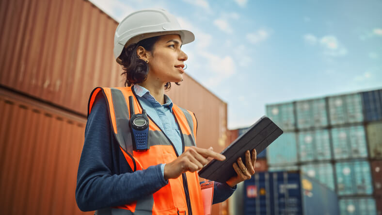 Female logistics manager outside a warehouse after logistics training