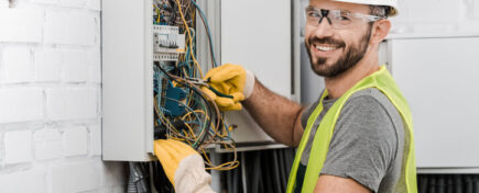Smiling male electrician at work after electrician training
