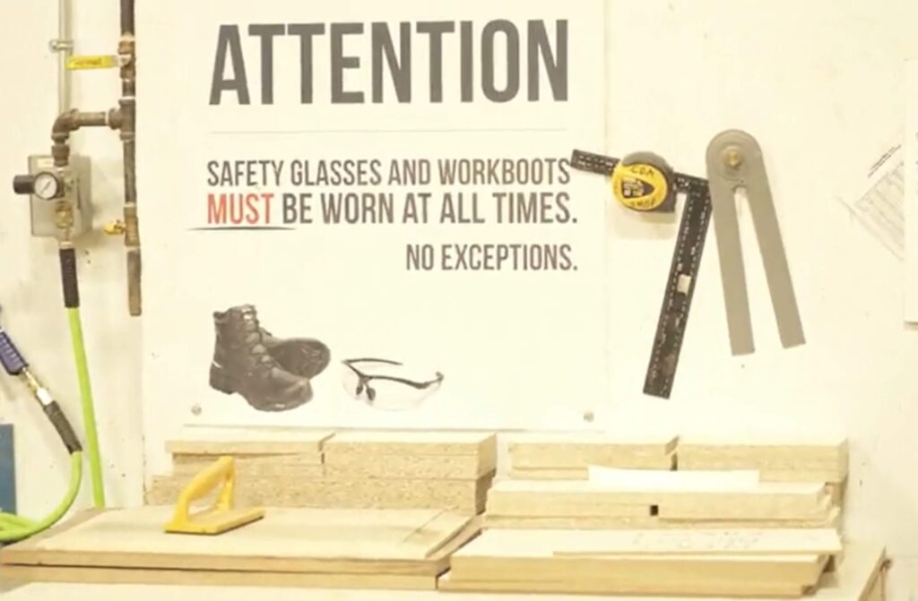 A safety reminder poster in a woodworking shop as seen in cabinet making training