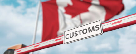 Canadian flag behind customs clearance barrier gate