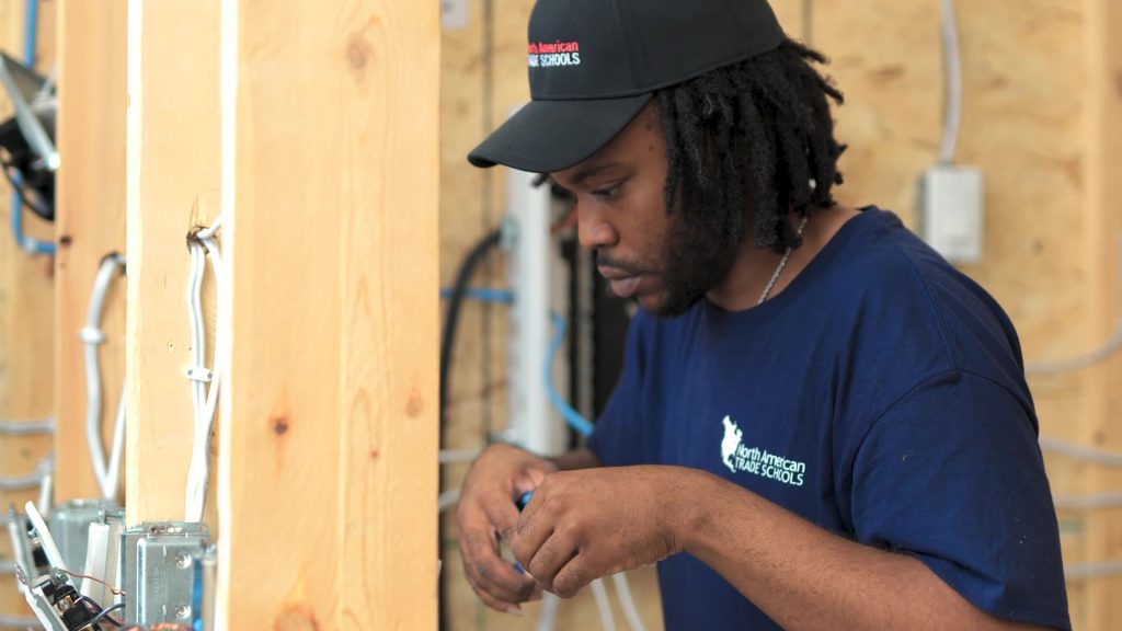image of CME student working on electrical wiring in the lab